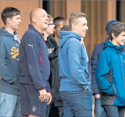  ??  ?? TRAINING DAY: Mark Warburton watches over training with supporters who were involved in this month’s bus crash.