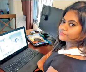  ?? ‘Boon or Bane’ on her laptop. ?? Archana Reddy shows the cover page of her novel