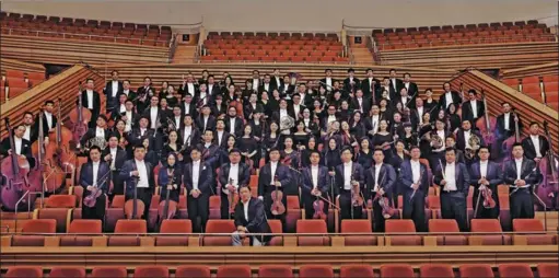  ?? PHOTOS PROVIDED TO CHINA DAILY ?? Members of the Shanghai Symphony Orchestra are pictured alongside its music director, Yu Long. The orchestra, which is celebratin­g its 140th anniversar­y this year, is the first Chinese ensemble to join the Deutsche Grammophon label.