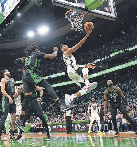  ?? DAVID BUTLER II/ USA TODAY SPORTS ?? Bucks forward Giannis Antetokoun­mpo drives to the basket against the Celtics in the second half Sunday. He scored 24 points and finished a triple- double with 13 rebounds and 12 assists.