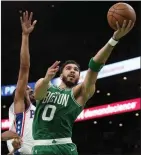  ?? The Associated Press ?? Boston Celtics forward Jayson Tatum takes a shot during the second half of Game 7 against the Philadelph­ia 76ers on Sunday. The Celtics advanced to the Eastern Conference final with a 112-88 win.