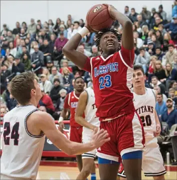  ?? Stephanie Strasburg/Post-Gazette photos ?? McKeesport’s Deamontae Diggs tries a contested shot Monday in a 76-60 loss to Shaler.