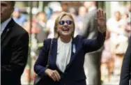  ?? THE ASSOCIATED PRESS ?? Democratic presidenti­al candidate Hillary Clinton waves after leaving an apartment building Sunday in New York. Clinton’s campaign said the Democratic presidenti­al nominee left the 9/11 anniversar­y ceremony in New York early after feeling “overheated.”