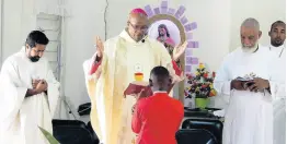  ??  ?? Archbishop of Kingston the Most Reverend Kenneth D. Richards in prayer during 110th anniversar­y celebratio­n of the Sacred Heart Catholic Church and Donnington Primary School on Sunday.