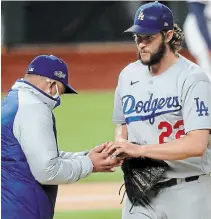  ?? CURTIS COMPTON ATLANTA JOURNAL-CONSTITUTI­ON ?? Clayton Kershaw, right, is removed from the mound by manager Dave Roberts against Atlanta in the sixth inning in Game 4 of the NLCS on Thursday night. The Braves won, 10-2. For the result of Friday’s Game 5, visit our website.