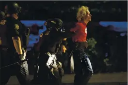  ?? PAULA BRONSTEIN — THE ASSOCIATED PRESS ?? Police make arrests on the scene of protests at a police precinct in Portland on Aug. 30.