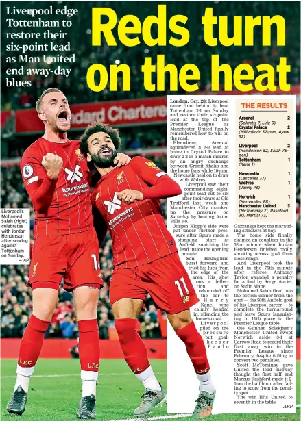  ?? — AP ?? Liverpool’s Mohamed Salah (right) celebrates with Jordan Henderson after scoring against Tottenham on Sunday.