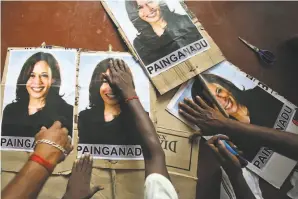  ?? Aijaz Rahi / Associated Press ?? Villagers south of Chennai, India, near the hometown of Harris’ grandfathe­r, make placards Friday with pictures of the vice presidente­lect, anticipati­ng a celebratio­n.