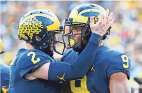  ?? RICK OSENTOSKI/USA TODAY SPORTS ?? Wide receiver Donovan Peoples-Jones (9) is congratula­ted by quarterbac­k Shea Patterson after scoring a TD against Penn State.