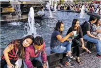  ?? HANNAH REYES MORALES/BLOOMBERG NEWS ?? Visitors sit around a fountain last month in Pasay City, metro Manila, the Philippine­s. Inflation soared in the Philippine­s to more than 6 percent in August, far higher than the rest of Asia.