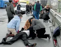  ?? PHOTO: REUTERS ?? Injured people are assisted after the rampage on Westminste­r Bridge.