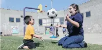  ?? RICH PEDRONCELL­I/ THE ASSOCIATED PRESS ?? Prisoner Erica Carmona, 21, tosses a soccer ball back and forth with her three- year- old son during his visit to the Folsom Women’s Facility in Folsom Calif.