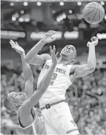  ?? Orlin Wagner / Associated Press ?? Keenan Evans, right, is fouled by Texas guard Matt Coleman during a quarterfin­als game of the Big 12 tournament Thursday. Evans helped Texas Tech advance with a team-high 25 points.