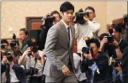  ?? KOJI SASAHARA - THE ASSOCIATED PRESS ?? FILE - In this Nov. 11, 2017, file photo, Japanese pitcherout­fielder Shohei Ohtani arrives for a press conference at the Japanese National Press Center in Tokyo. Japanese star Shohei Ohtani is bringing his arm and bat to the Los Angeles Angels, pairing...