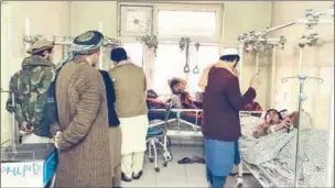  ?? ?? Wounded Afghan men receive treatment at a hospital following a blast at a madrassa in Aybak city of Samangan province on Wednesday.