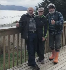  ??  ?? Pictured on the deck of the house overlookin­g the Inlet of Haida Gwaii that’s all set up for a Syrian family of eight are, from left, Bruce Ives, Fran Fowler and Carl Coffey, members of Operation Refugees.