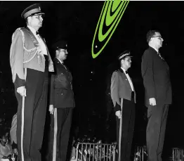  ??  ?? Acting Prime Minister Donald Sangster receiving a general salute after his arrival at the stadium for the opening of the Eighth British Empire and Commonweal­th Games. Behind him on the saluting dais are (from left); Brigadier David Smith, chief of staff of the Jamaica Defence Force; Police Superinten­dent Orville Day and Major Rudolph Green.