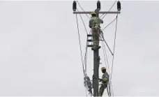  ??  ?? Technician­s worked yesterday to restore power in Salalah, Oman, after Cyclone Mekunu tore through the sultanate