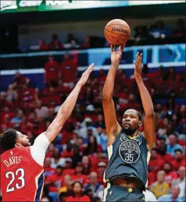  ?? GERALD HERBERT/THE ASSOCIATED PRESS ?? Golden State Warriors forward Kevin Durant (35) shoots against New Orleans Pelicans forward Anthony Davis (23) in the first half of Game 4 of a second-round NBA playoff series Sunday in New Orleans.