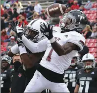  ?? See more photos at arkansason­line.com/111asutroy/. (Arkansas Democrat-Gazette/Thomas Metthe) ?? Troy cornerback Terence Dunlap (1) breaks up a pass intended for Arkansas State receiver Corey Rucker during the third quarter Saturday at Centennial Bank Stadium in Jonesboro. Arkansas State lost 38-10 to fall to 1-3 in the Sun Belt Conference.