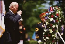  ?? Andrew Harnik / Associated Press ?? President Joe Biden salutes after laying a wreath at The Tomb of the Unknown Soldier at Arlington National Cemetery on Memorial Day, Monday, in Arlington, Va.