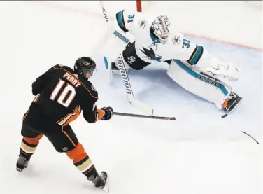  ?? Chris Carlson / Associated Press ?? Martin Jones, who has stopped 53 shots in the first two games of the series, foils Corey Perry in Game 2.