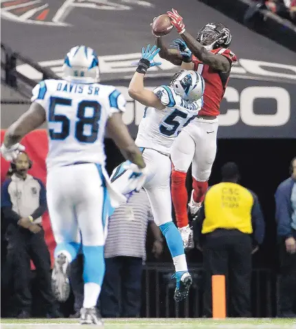  ?? DAVID GOLDMAN/THE ASSOCIATED PRESS ?? Atlanta receiver Julio Jones (11) catches the ball over Carolina middle linebacker Luke Kuechly (59) on his way to a touchdown in the second half of Sunday’s game in Atlanta. The Falcons handed the Panthers their first loss of the season.