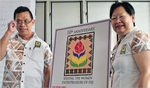  ?? Picture: JONA KONATACI ?? South Pacific Business Developmen­t general manager Elrico Munoz and director Jenny Seeto with the new logo after its launch yesterday.