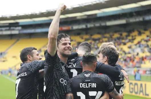  ?? GETTY IMAGES ?? Wellington Phoenix players celebrate their match-winning goal in their last clash, against Brisbane Roar.