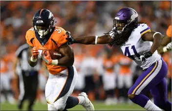  ??  ?? in this Aug. 11 file photo, Denver broncos running back royce Freeman (left) breaks away from Minnesota vikings safety Anthony Harris way his way to a touchdown during the first half in an NFL football preseason game in Denver. AP PHOtO/MARk REiS