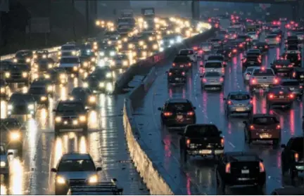  ?? THE ASSOCIATED PRESS ?? Early morning rush hour traffic crawls along the Hollywood Freeway toward downtown Los Angeles. One promise of ride-hailing companies was a drop in the number of cars in urban areas and an easing of clogged city streets. But a survey by an urban...