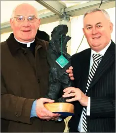  ??  ?? Monsignor Kehoe receiving a presentati­on from GAA president Christie Cooney at the Glynn-Barntown GAA Club’s 125-year celebratio­ns in October 2010. The presentati­on was made to recognise Monsignor Kehoe’s dedication to the club over the years.