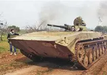  ?? AFP ?? A rebel tank driving down an unpaved road near the town of Maardes in the Syrian province of Hama.