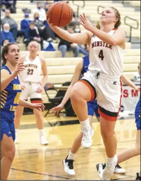  ?? Staff photo/David Pence ?? Minster’s Ivy Wolf drives to the basket in a Midwest Athletic Conference girls basketball game on Thursday against Marion Local.