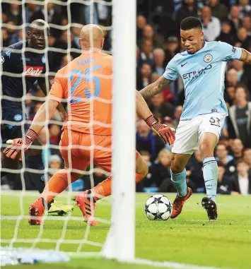  ?? PHOTO: AFP. ?? Manchester City’s Gabriel Jesus (right) scores the second goal against Napoli during their UEFA Champions League Group F match at the Etihad Stadium…yesterday.