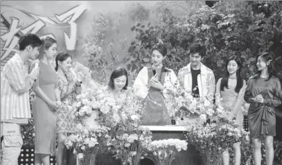  ?? ?? With nearly 2.2 million followers on short-video platform Douyin, Zhao Yun (fourth from left) demonstrat­es her floral design skills on a China Central Television program in Beijing.