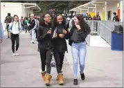  ?? LIPO CHING — STAFF PHOTOGRAPH­ER ?? From left, Kayla Branner, Shayla Branner and Alana Kochieva walk to class at Summit Shasta charter school.