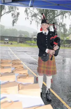  ??  ?? Former pupil
Harry Russell piped the P7s out of the playground