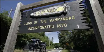  ??  ?? BACK ON TRACK: A wooden sign advises motorists of the location of Mashpee Wampanoag Tribal lands on Cape Cod. Tribe Chairman Cedric Cromwell announced in March that the federal Bureau of Indian Affairs told them that the tribe’s reservatio­n will be ‘disestabli­shed’ and its land taken out of trust. The U.S. District Court just overturned that desision.