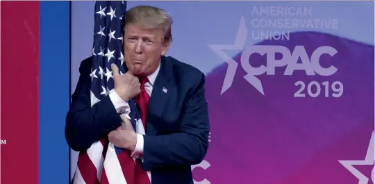  ?? (SIPA) ?? Donald Trump hugs the American flag at the American Conservati­ce Union convention in 2019.