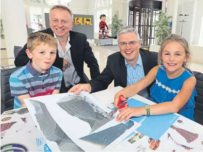  ?? Picture: Gareth Jennings. ?? DC Thomson director and chief operating officer David Thomson, right, and Philip Long help Jamie and Emily Thomson with their pop-up books at a preview event at the Counting House in the firm’s Dundee headquarte­rs to celebrate news of the naming of the V&amp;A suite.