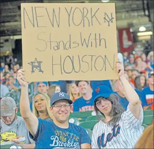  ?? Austin Miller ?? WE GOT YOUR BACK: New York fans Mike Landau (left) and Rachel Marks were in attendance for Saturday’s Mets-Astros game at Minute Maid Park, the first sporting event in Houston since the city was inundated by Hurricane Harvey.