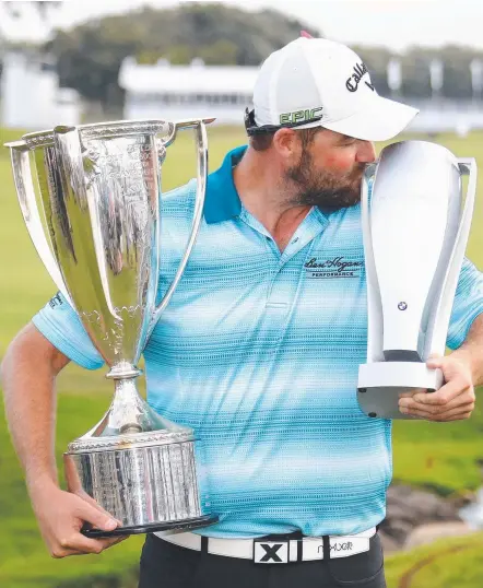  ?? Picture: GETTY IMAGES ?? Marc Leishman poses with the Wadley Cup and the BMW Championsh­ip Trophy.