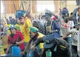  ??  ?? NOT HAPPY: Members of the crowd threaten to throw chairs at the stage during the Langa Massacre commemorat­ion event in Uitenhage