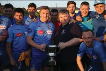  ??  ?? North End United captain Paul Murphy receives the trophy from Philip O’Brien of the Wexford League.