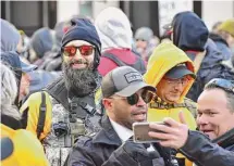  ?? Anthony Crider/For The Washington Post ?? Proud Boy Jeremy Bertino, wearing a beard, sunglasses and knit hat, attends a rally in Richmond, Va., in January 2020. Proud Boys leader Henry “Enrique” Tarrio is wearing sunglasses and a cap.