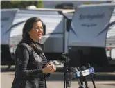  ?? Paul Chinn / The Chronicle ?? Oakland Mayor Libby Schaaf, on Hegenberge­r Road near the Coliseum, announces the opening of 67 trailers for homeless people most at risk from the coronaviru­s.