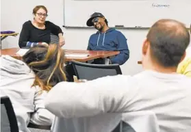  ?? KENNETH K. LAM/BALTIMORE SUN ?? Johns Hopkins professor Toby Gordon and rapper Diablo Flamez teach a seminar at the university about health disparitie­s based on the HBO series “The Wire.” They are from different parts of the city but have found common ground in many ways.