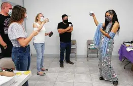  ?? Kin Man Hui / Staff photograph­er ?? Political newcomer Rebeca “Becky” Clay-Flores, right, raises a glass of sparkling grape juice as she rejoices with her staff on Tuesday night.