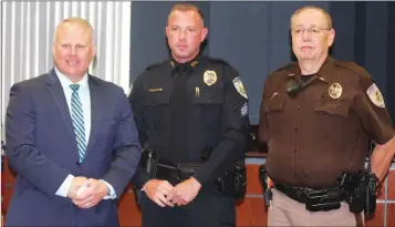  ??  ?? ABOVE: Sgt. Jeff Parsons, center, attends a ceremony in honor of his promotion at the Benton Police Department. Also pictured are BNPD Chief Scotty Hodges and Saline County Sheriff's Office Lt. Ronald Parsons.